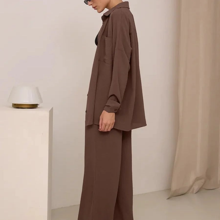 Elegant feminine set consisting of shirt and trousers